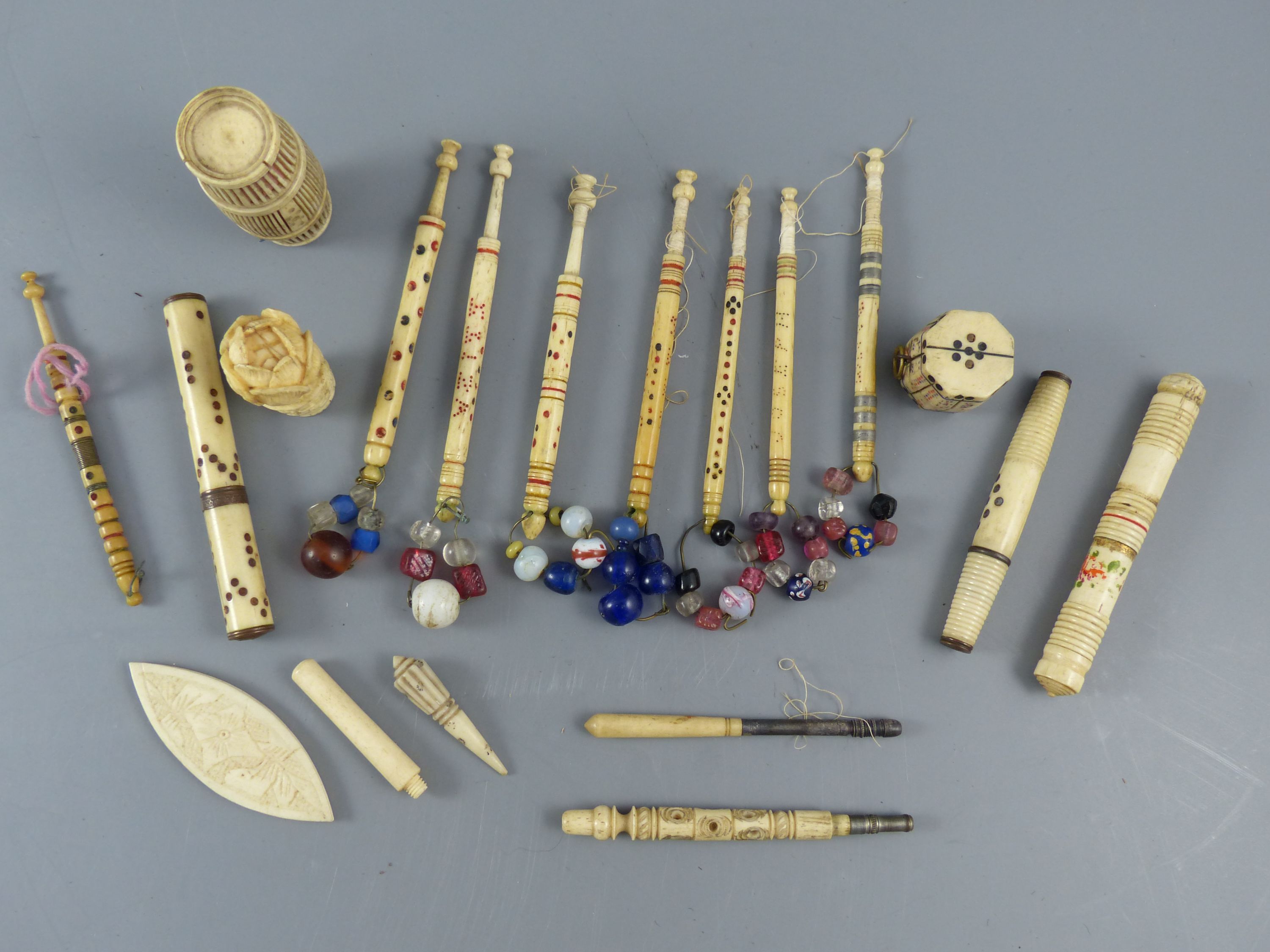 A collection of assorted 19th century stained ivory and bone sewing implements
